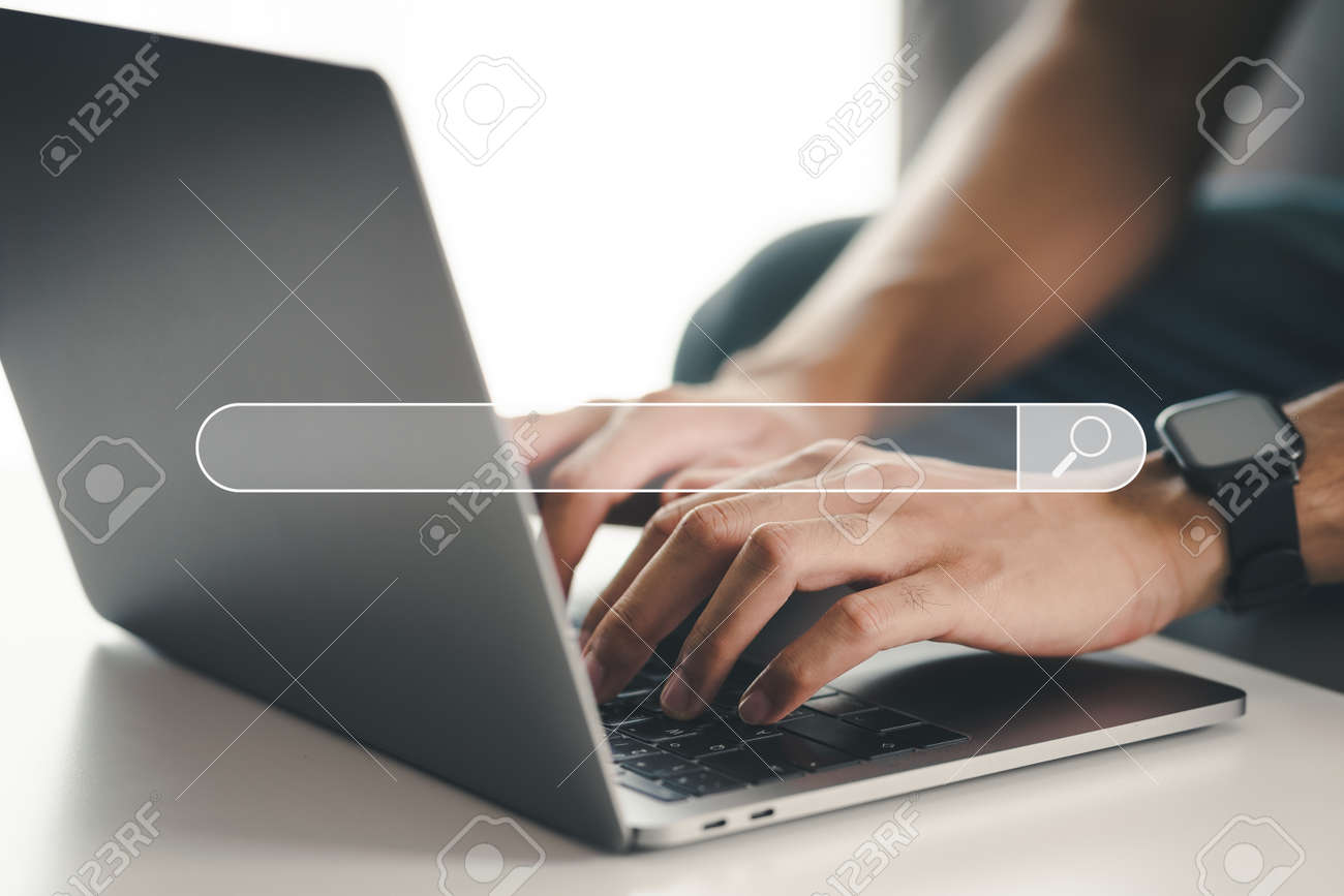 Man using a laptop computer to Searching for information with the Search bar, Web browser, Data Search, Search Engine, Technology Concept - 171855762 Man using a laptop computer to Searching for information with the Search bar, Web browser, Data Search, Search Engine, Technology Concept - 171855762