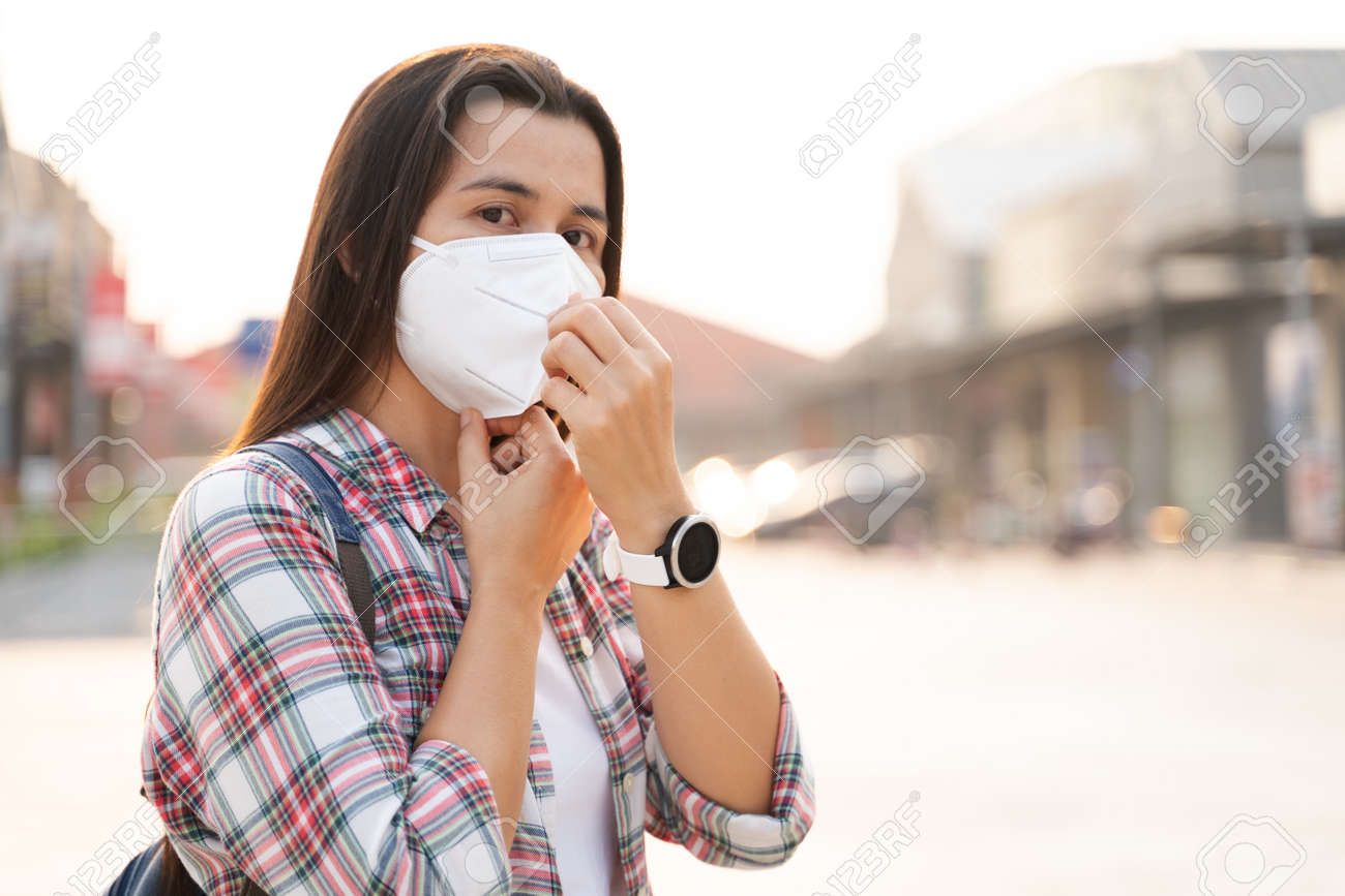 Asian woman wearing N95 face mask to protect pollution PM2.5 and virus. COVID-19 Coronavirus and Air pollution pm2.5 Healthcare and medical concept. - 171949185 Asian woman wearing N95 face mask to protect pollution PM2.5 and virus. COVID-19 Coronavirus and Air pollution pm2.5 Healthcare and medical concept. - 171949185