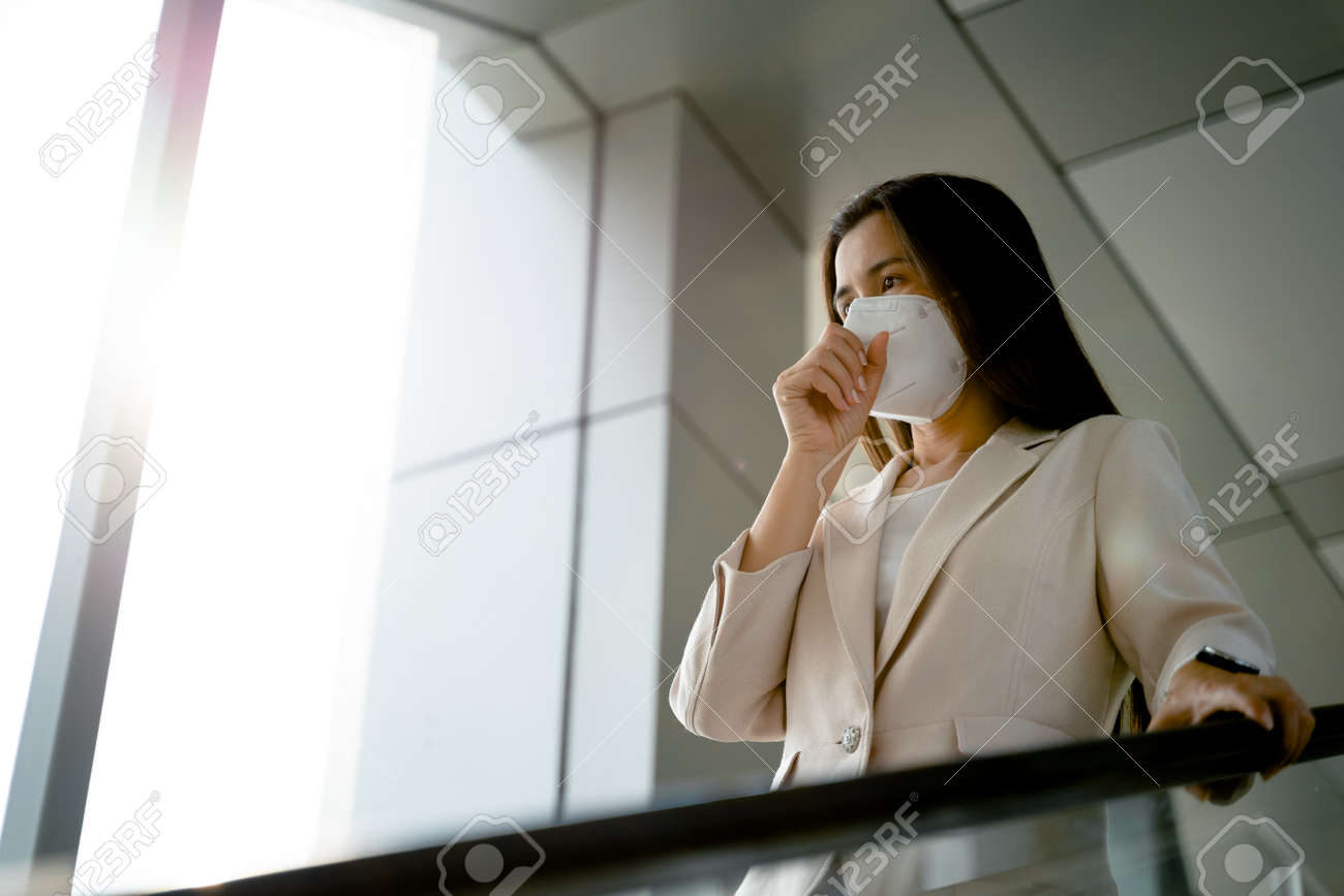 Asian woman wearing N95 face mask to protect pollution PM2.5 and virus. COVID-19 Coronavirus and Air pollution pm2.5 Healthcare and medical concept. - 171949186 Asian woman wearing N95 face mask to protect pollution PM2.5 and virus. COVID-19 Coronavirus and Air pollution pm2.5 Healthcare and medical concept. - 171949186