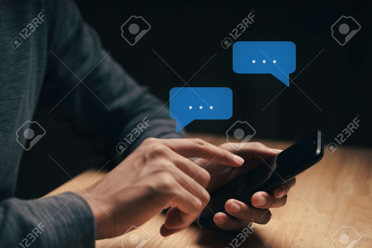 Young man using smartphone typing, chatting conversation with pop up chat box icons. Social Network, technology concept - 172263058 Young man using smartphone typing, chatting conversation with pop up chat box icons. Social Network, technology concept - 172263058