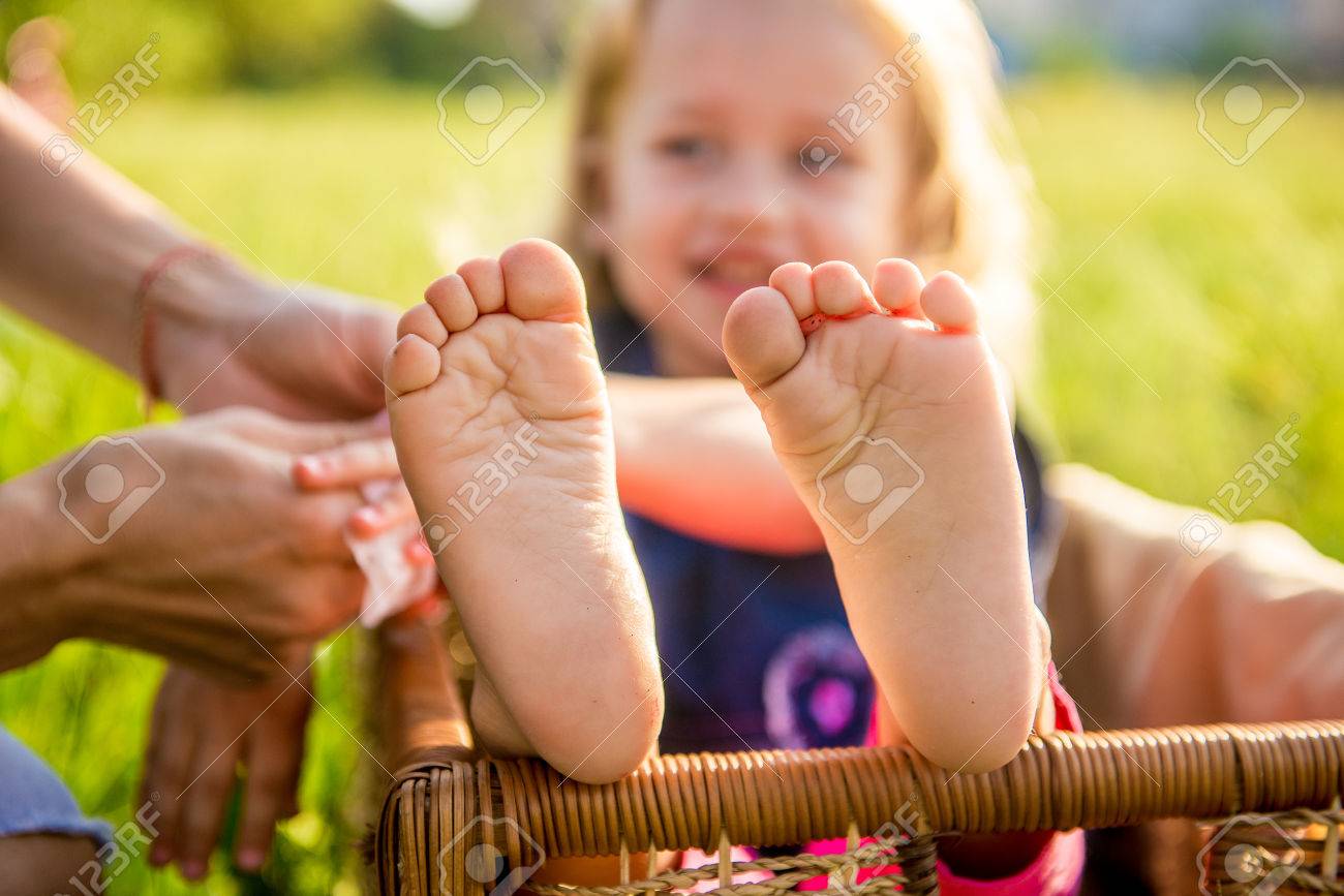 Little Girls Feet Sitting In A Wicker Basket On A Sunny Day In Stock Photo Picture And Royalty Free Image Image