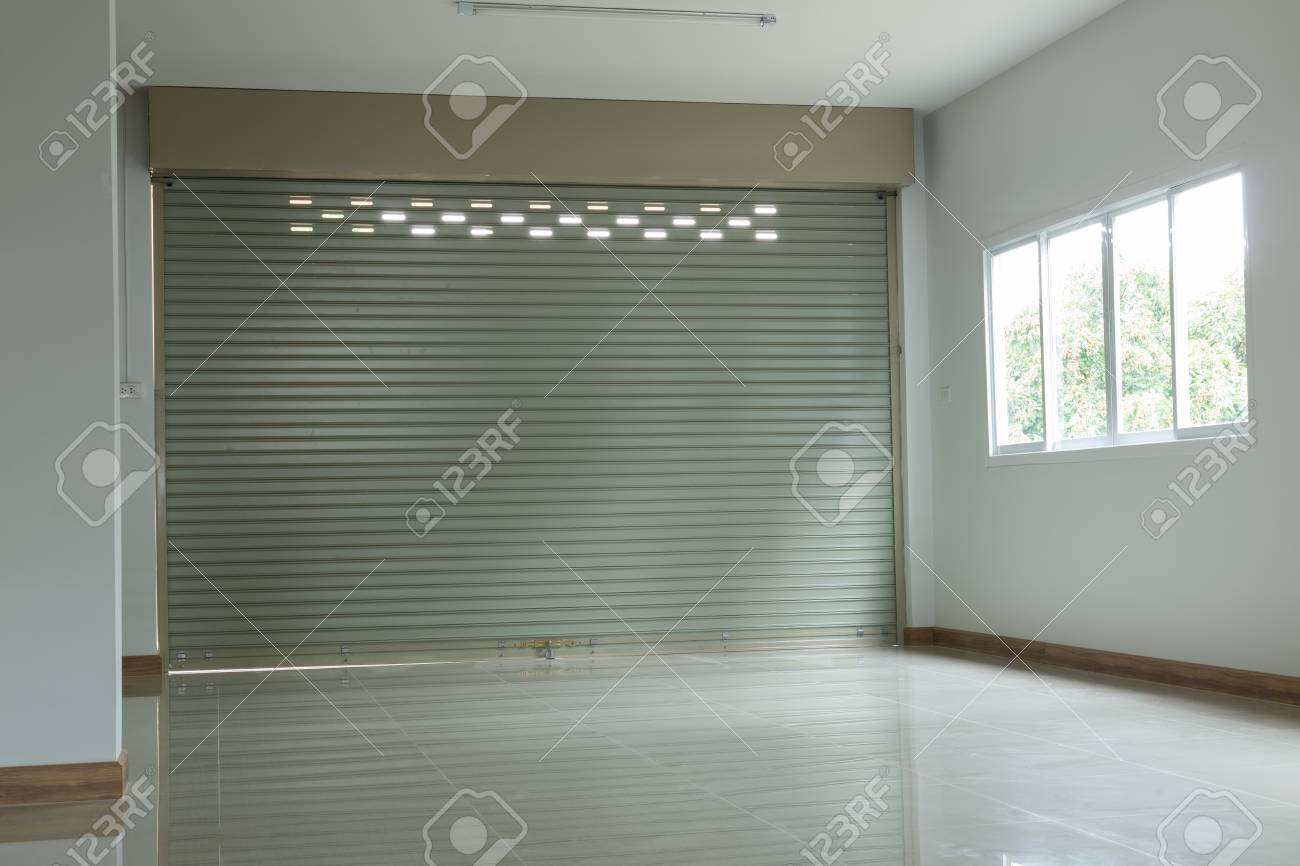 Empty Room In House Residential Building With Aluminium Roller Empty Room In House Residential Building With Aluminium Roller Shutter Door And Window Glass Sliding
