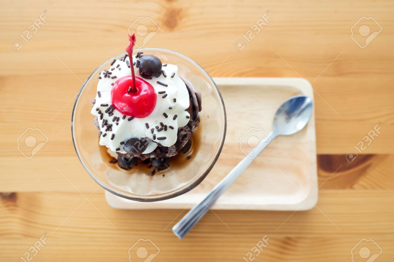 Chocolate Sundae Ice Cream Served With Whipping Cream And Cherry On Top.  Pour Chocolate Sauce And Chocolate Ball. On Wooden Tray. Top View. Stock  Photo, Picture and Royalty Free Image. Image 89633118., image size:1300x866