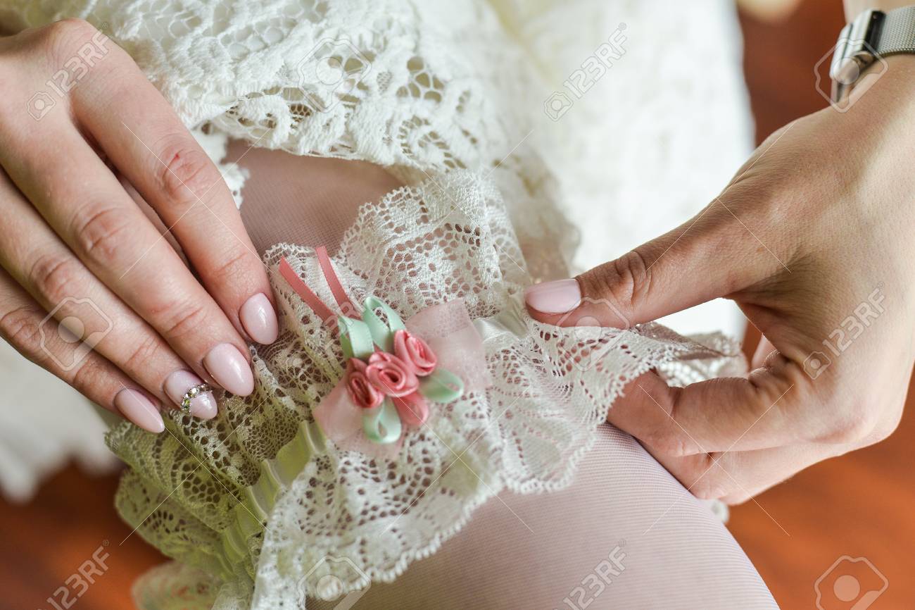 Brides Garter On The Leg Beautiful Bride Sitting On Bed And Stock Photo Picture And Royalty Free Image Image 94289985