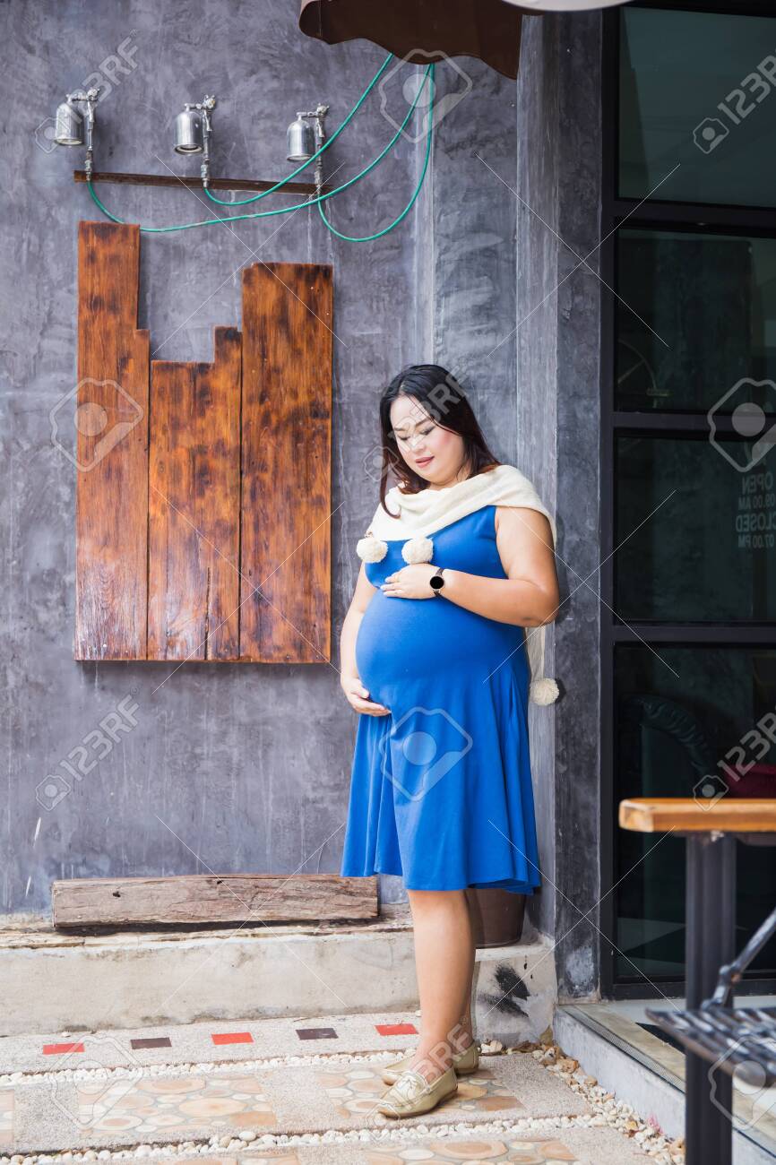 Photo Of Pregnant Belly Pregnant Woman In Dress Holds Hands Stock Photo Picture And Royalty Free Image Image 129347244
