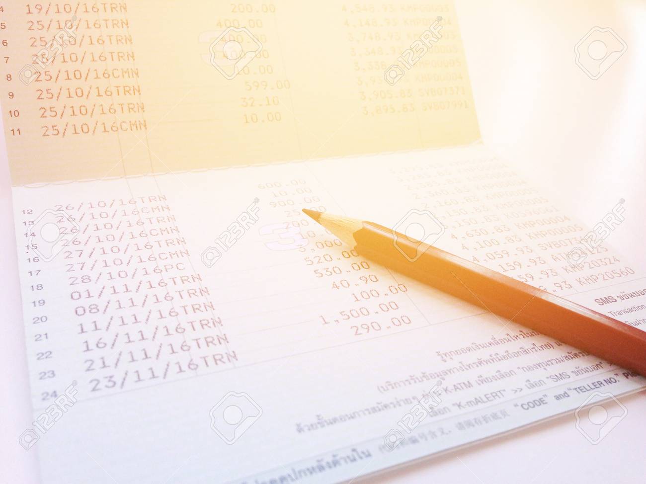 Business, finance, saving money, investment or accounting concept : Saving account book or financial statement and pen on office desk table - 126599872 Business, finance, saving money, investment or accounting concept : Saving account book or financial statement and pen on office desk table - 126599872