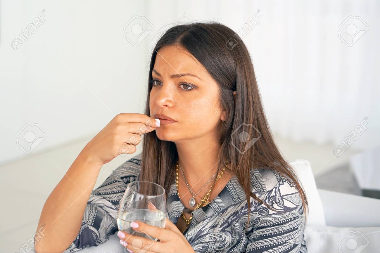 Sick Woman Taking Pill And Holding Glof Water At Home Depressed Unhealthy Woman Sick Woman Taking Pill And Holding Glof Water At Home Depressed Unhealthy Woman