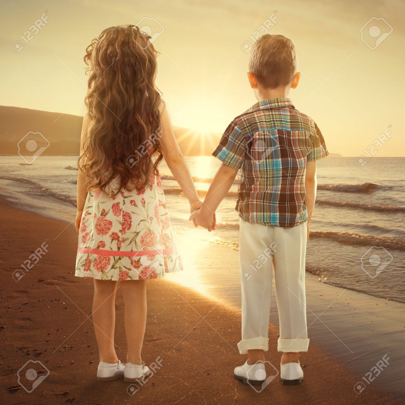 Back View Of Little Girl And Boy Holding Hands At Sunset Love ...