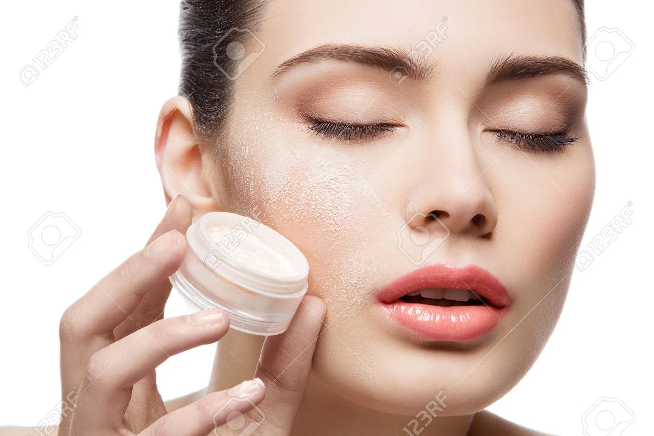 Beautiful young woman holding jar with loose powder near face. Closed eyes. Macro. Isolated over white background. Copy space. - 49142022 Beautiful young woman holding jar with loose powder near face. Closed eyes. Macro. Isolated over white background. Copy space. - 49142022