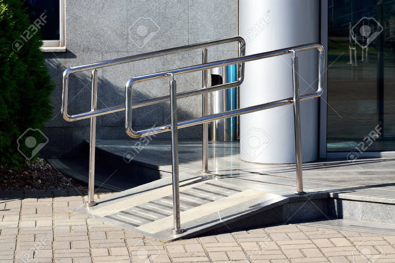 ramp for wheelchair entry with metal handrails stock photo picture