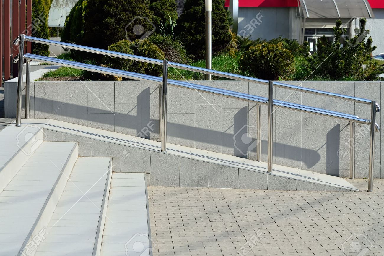 ramp for wheelchair entry with metal handrails stock photo picture