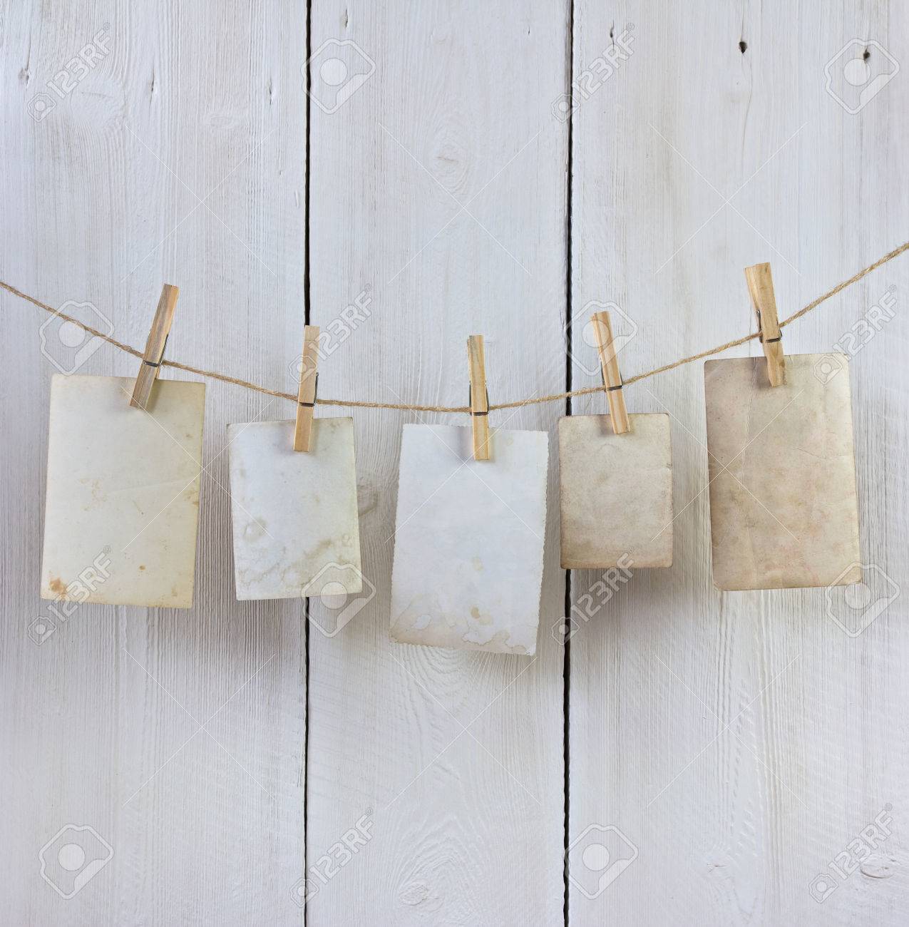 old photos hanging on the rope with a clothespin against white planks - 41921441 old photos hanging on the rope with a clothespin against white planks - 41921441