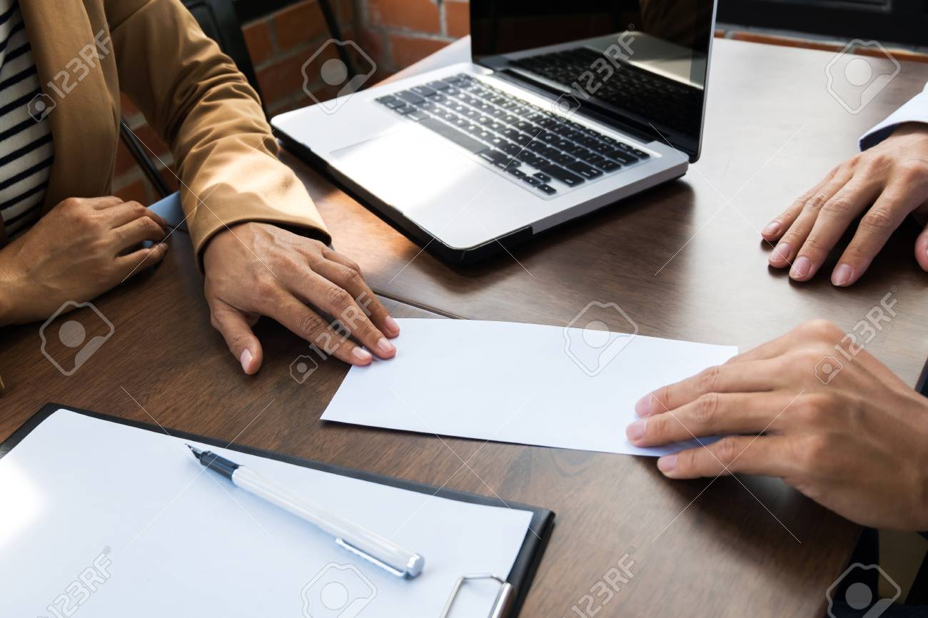 business man giving resignation letter to human resource manager giving resignation