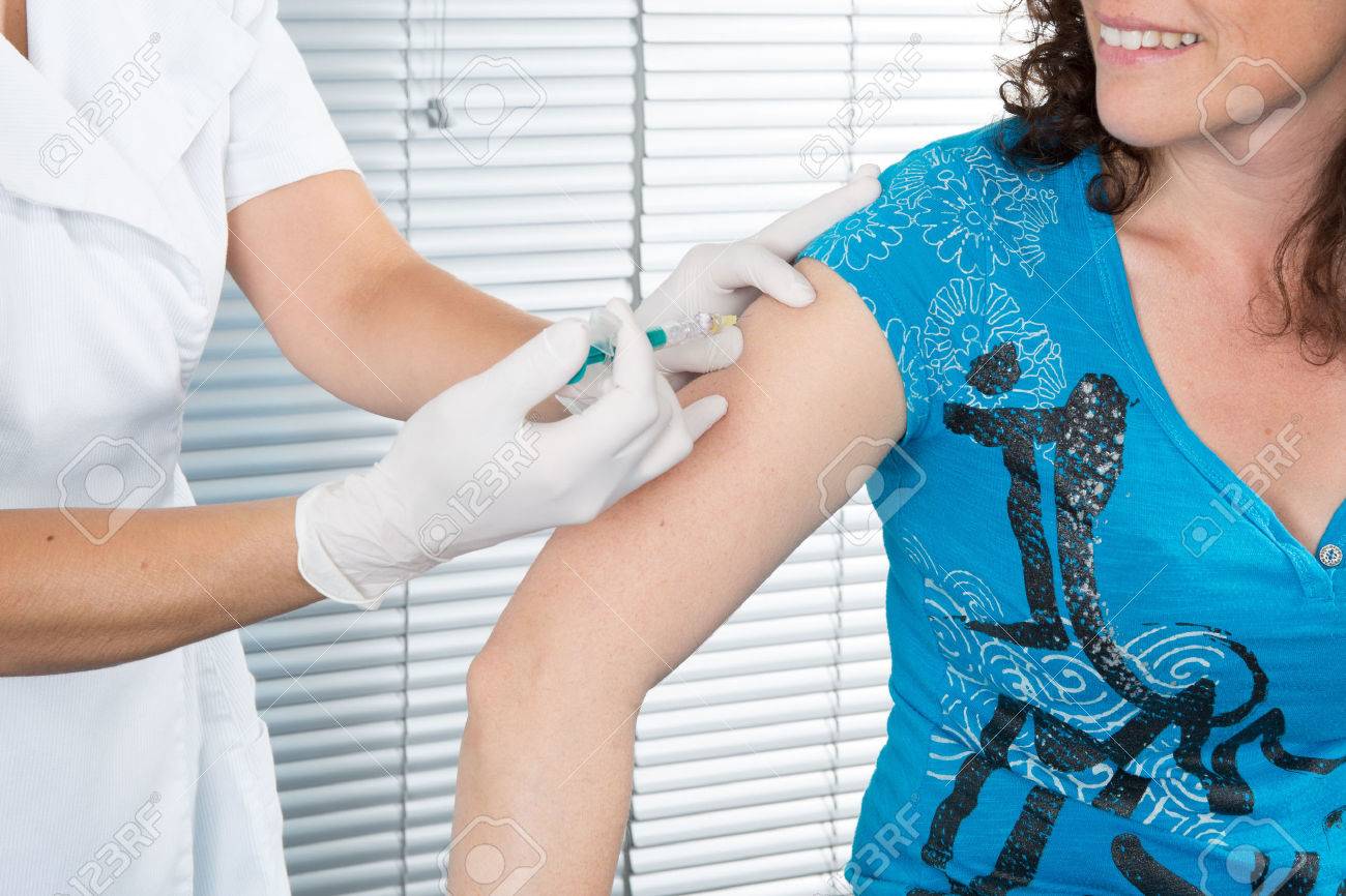 Close up of doctor giving an injection to a patient - 41012990 Close up of doctor giving an injection to a patient - 41012990