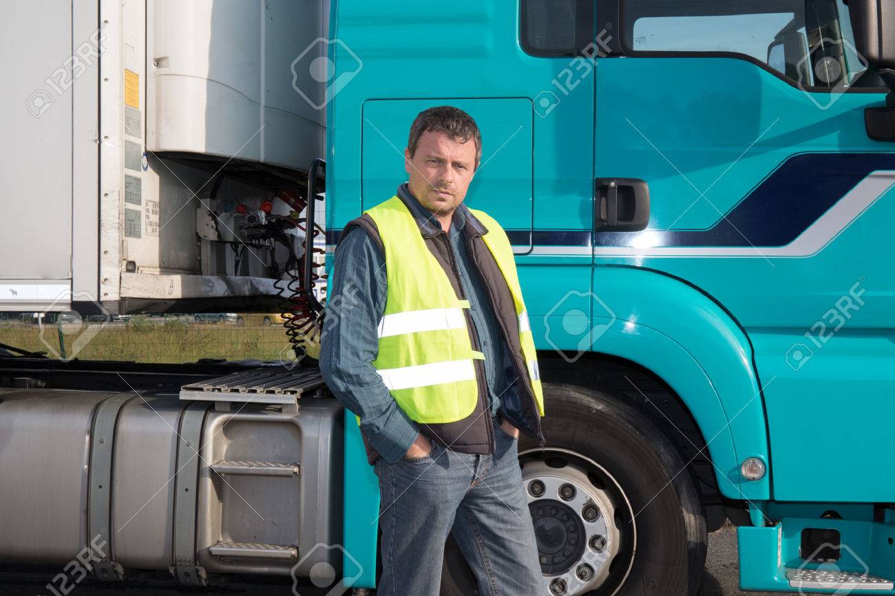 Serious and confident Man standing in front of truck - 47967079 Serious and confident Man standing in front of truck - 47967079