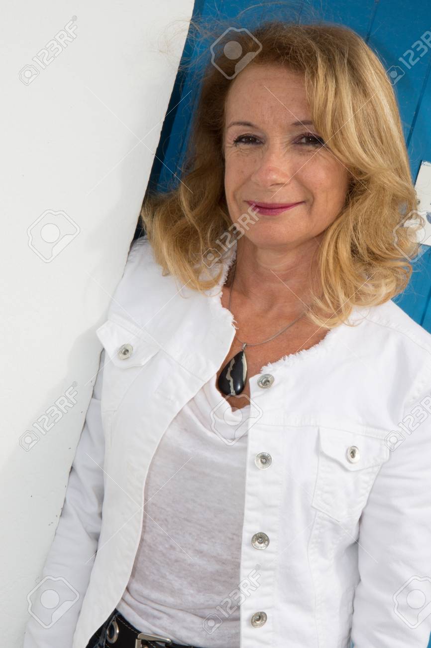mature girl poses senior portrait photo outdoors with wooden stock