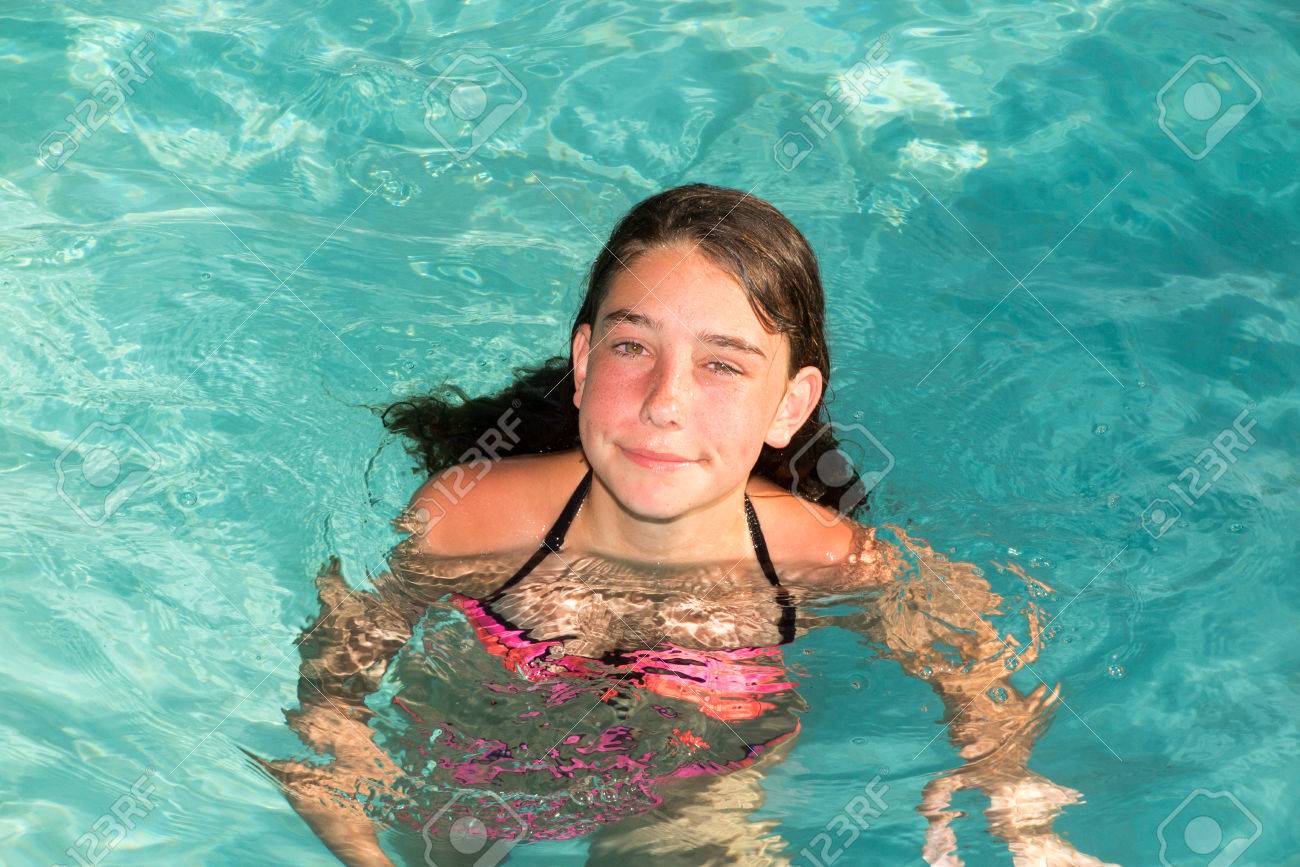 Happy Little Girl Teenager Playing In Outdoor Swimming Pool On Hot Summer Day Stock Photo Happy Little Girl Teenager Playing In Outdoor Swimming Pool On Hot Summer Day Stock Photo