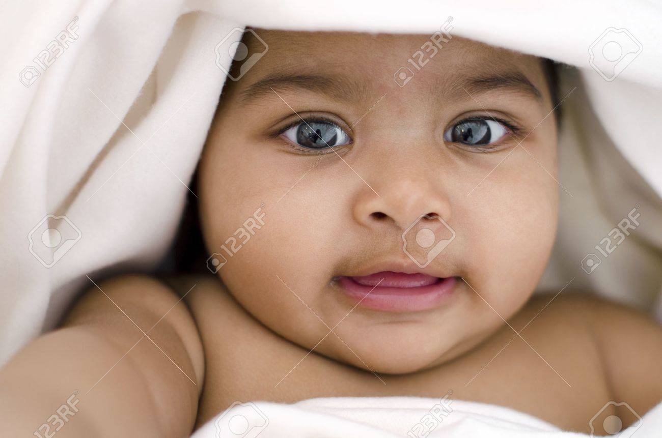 6 Months Old Indian Baby Girl Smiling Lying On Bed And Covered By Blanket Stock Photo Picture And Royalty Free Image Image
