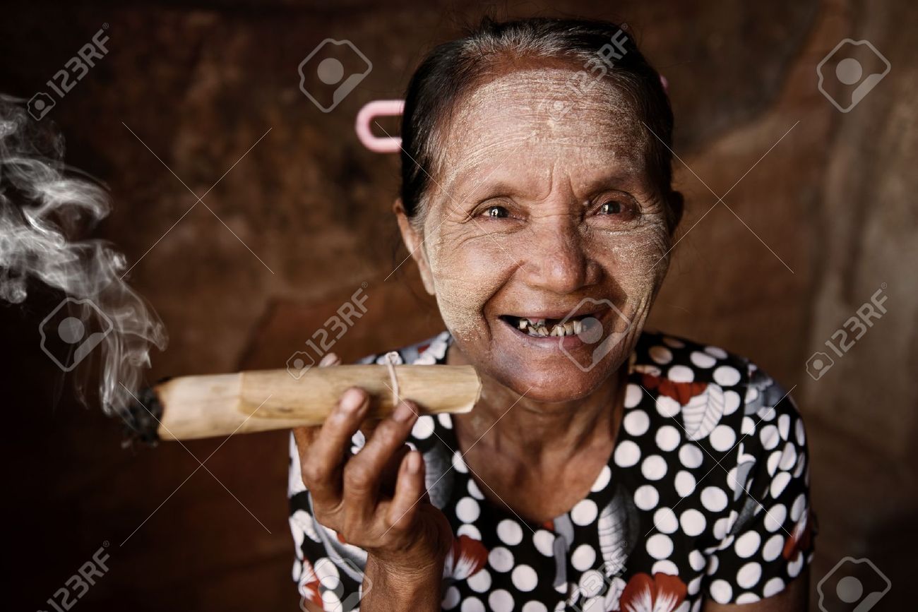 https://previews.123rf.com/images/szefei/szefei1309/szefei130900020/22112484-happy-old-wrinkled-asian-woman-smoking-traditional-tobacco-bagan-myanmar.jpg