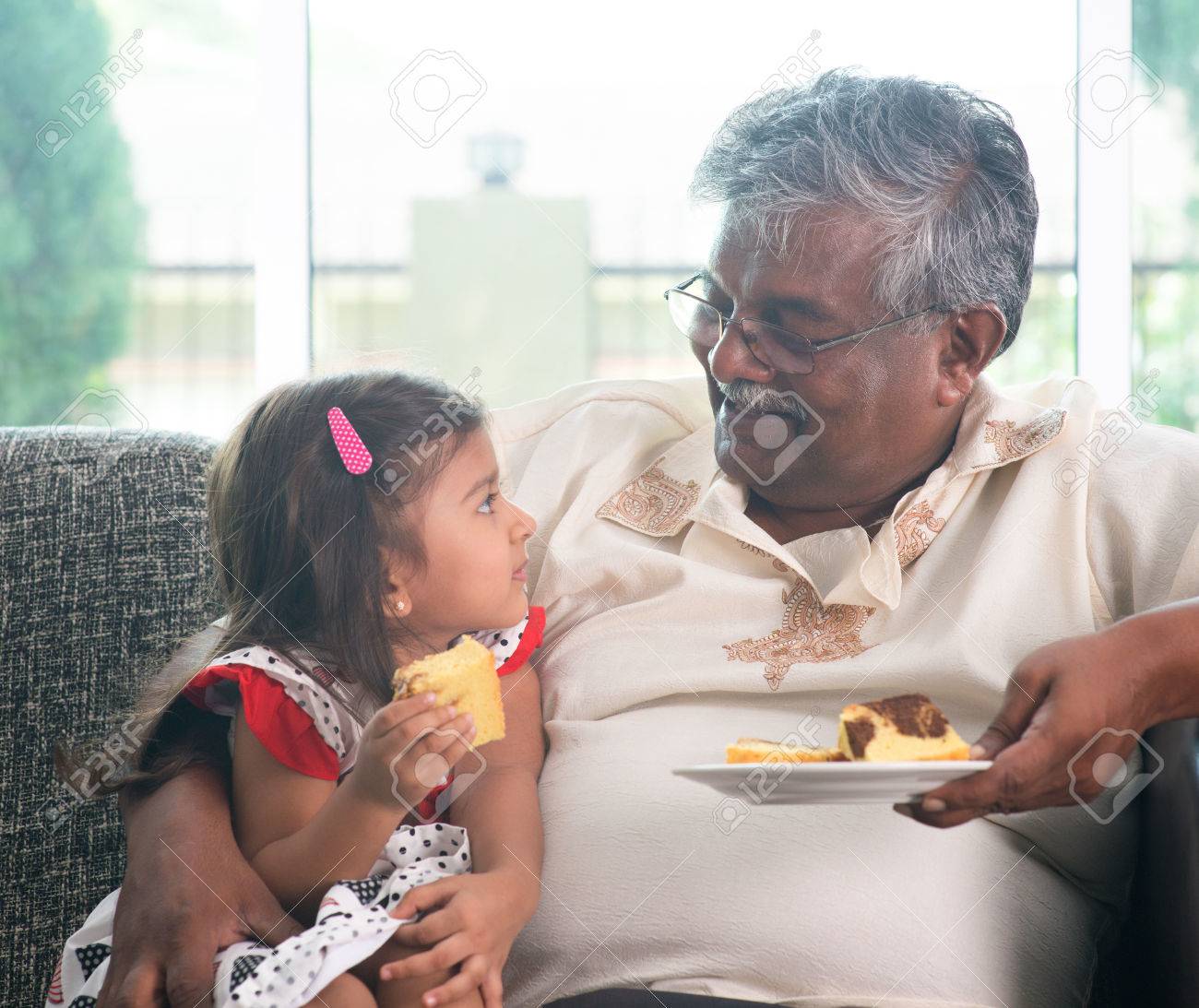 portrait indian family at home grandparent and grandchild eating