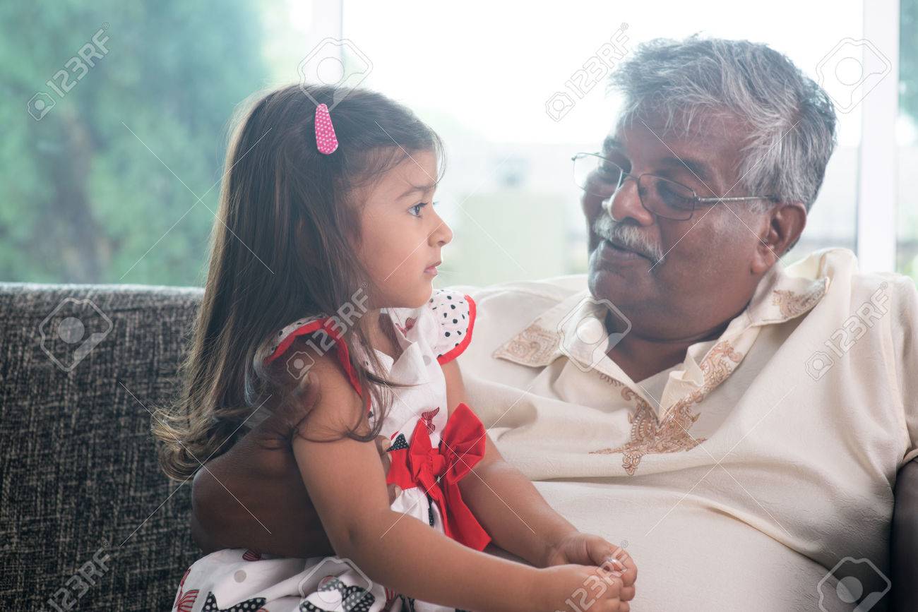 portrait indian family at home grandparent and grandchild talking