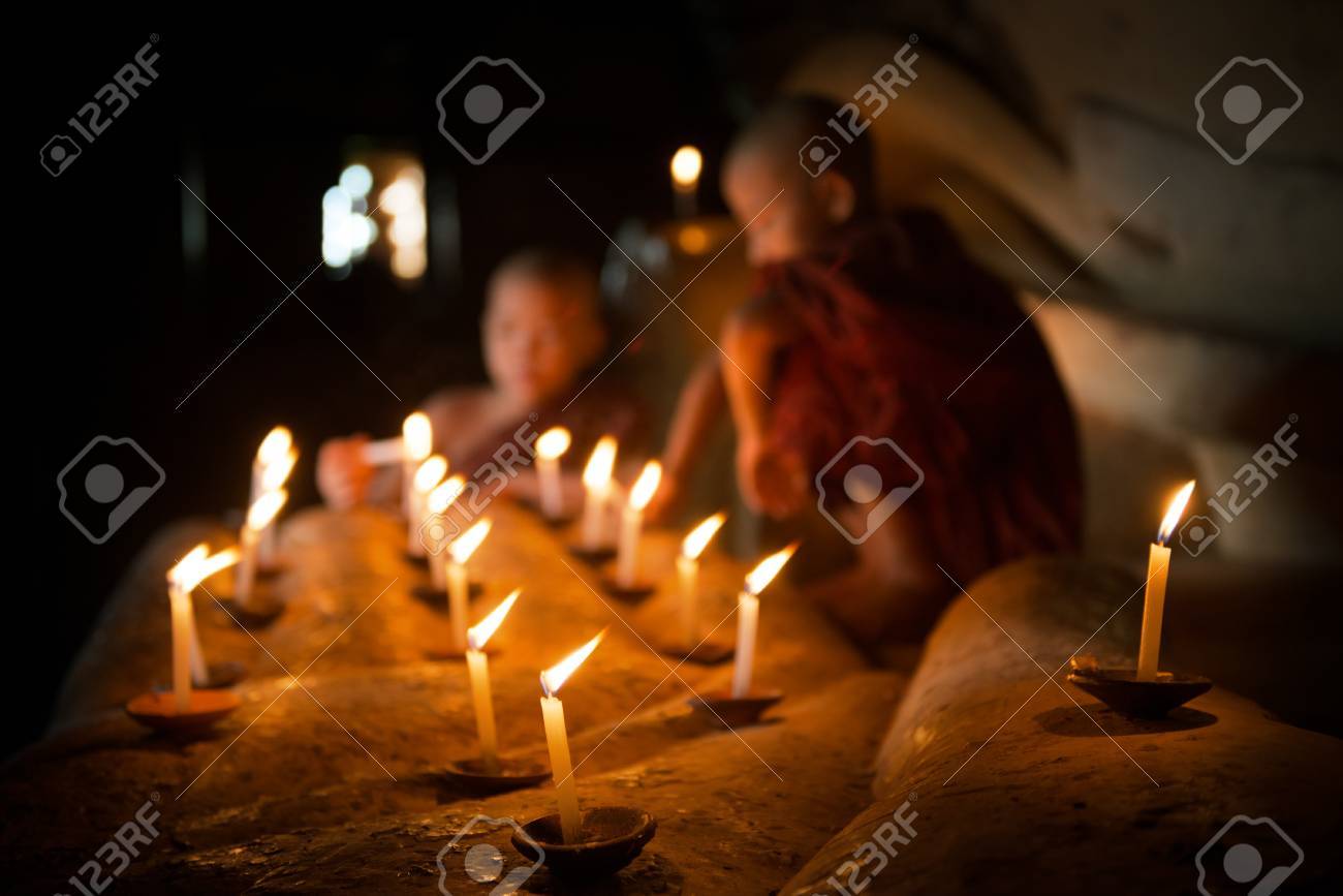 Little novice monks hand holding candlelight inside temple, Bagan, Myanmar. - 50022682 Little novice monks hand holding candlelight inside temple, Bagan, Myanmar. - 50022682