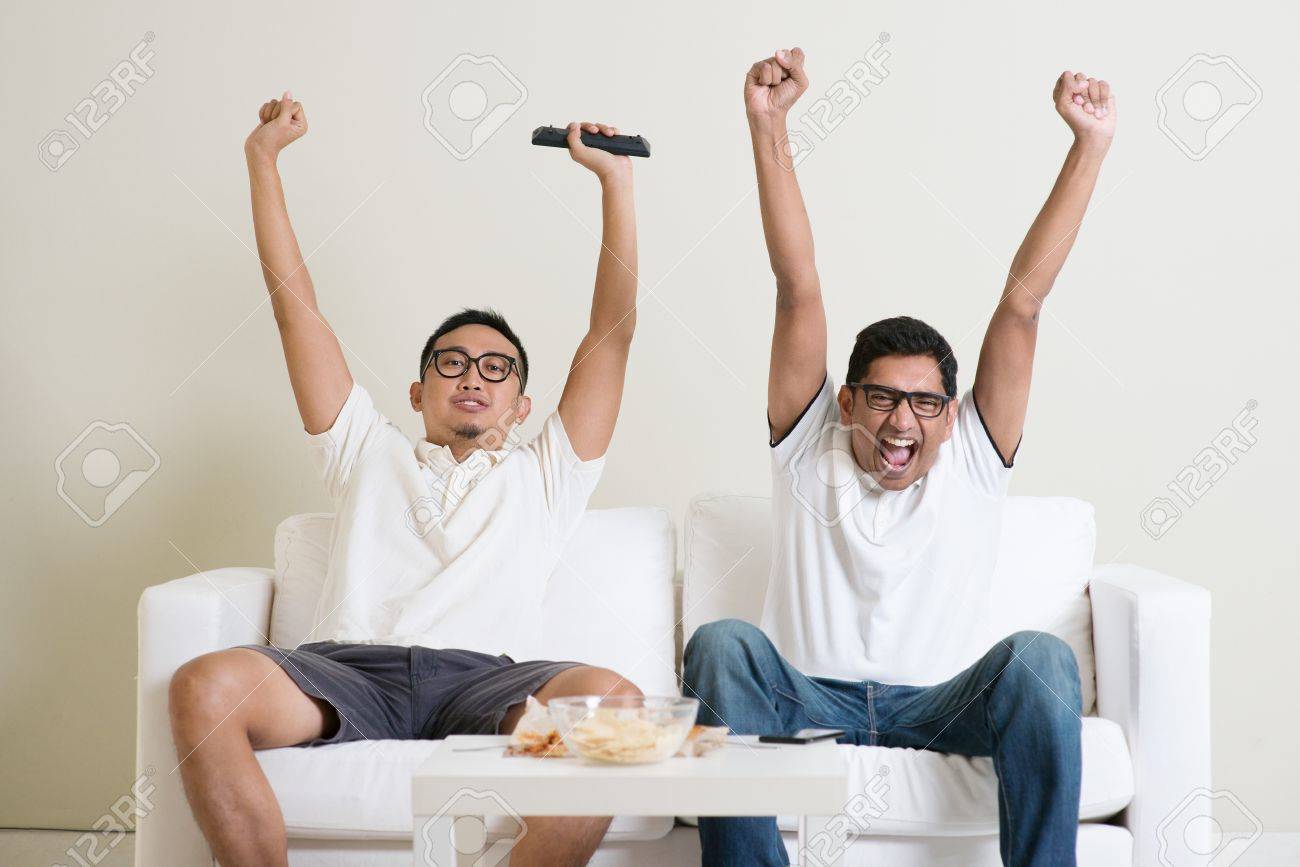 Friendship, technology and home concept. Happy male friends with remote control and junk food at home. - 50680694 Friendship, technology and home concept. Happy male friends with remote control and junk food at home. - 50680694