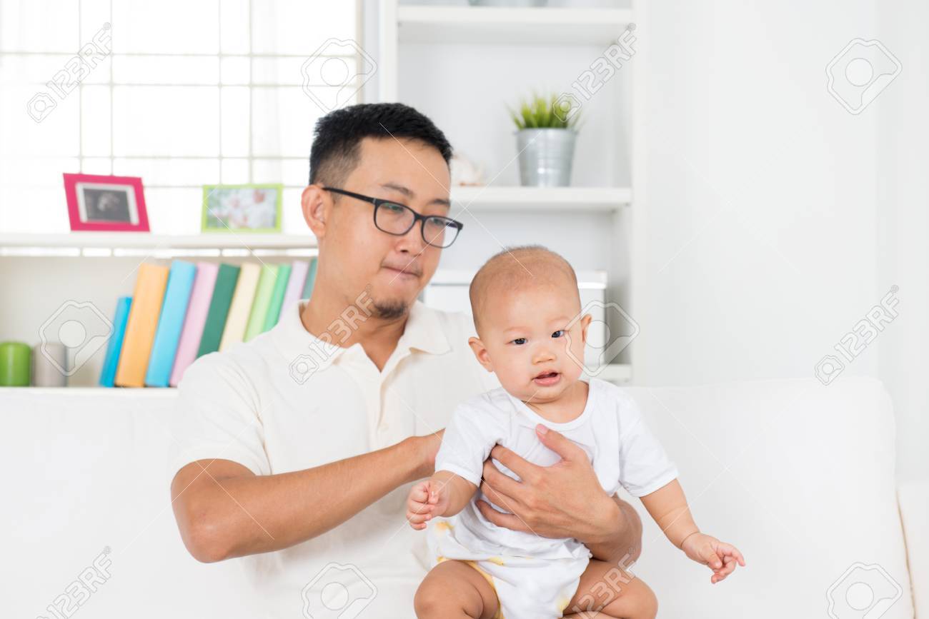 Father burping baby boy after meal, Asian family lifestyle at home. - 52943787 Father burping baby boy after meal, Asian family lifestyle at home. - 52943787