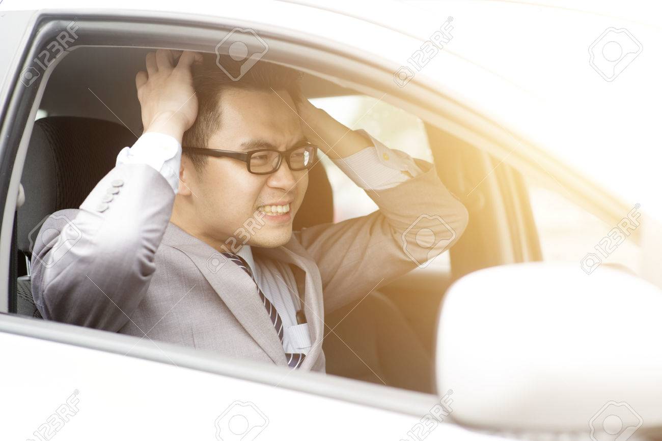 Portrait displeased angry pissed off aggressive Asian business man driving car, shouting at someone in traffic hands grabbing hair. Emotional intelligence concept. Negative human expression. - 74883019 Portrait displeased angry pissed off aggressive Asian business man driving car, shouting at someone in traffic hands grabbing hair. Emotional intelligence concept. Negative human expression. - 74883019
