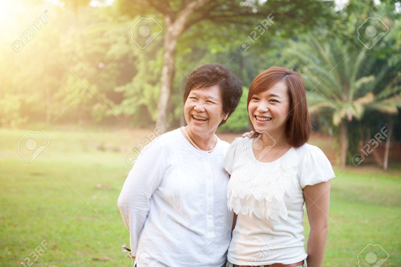 Portrait of happy Asian elderly mother and daughter, senior adult woman and grown child. Outdoors family at nature park with beautiful sun flare. - 75642398 Portrait of happy Asian elderly mother and daughter, senior adult woman and grown child. Outdoors family at nature park with beautiful sun flare. - 75642398