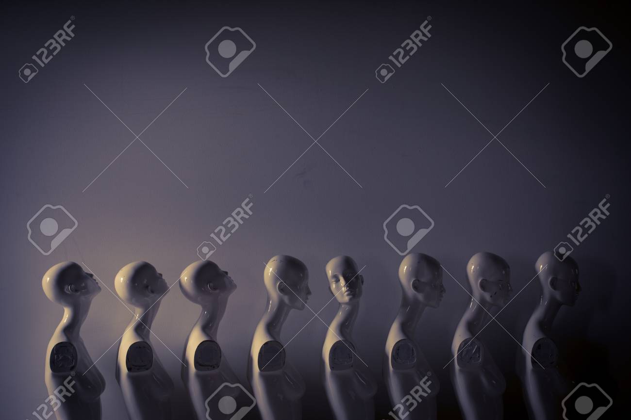 Plastic Woman Mannequins Standing in The Line, With One Looking to Another Direction then the Others in Melancholic Mood - 125136464 Plastic Woman Mannequins Standing in The Line, With One Looking to Another Direction then the Others in Melancholic Mood - 125136464