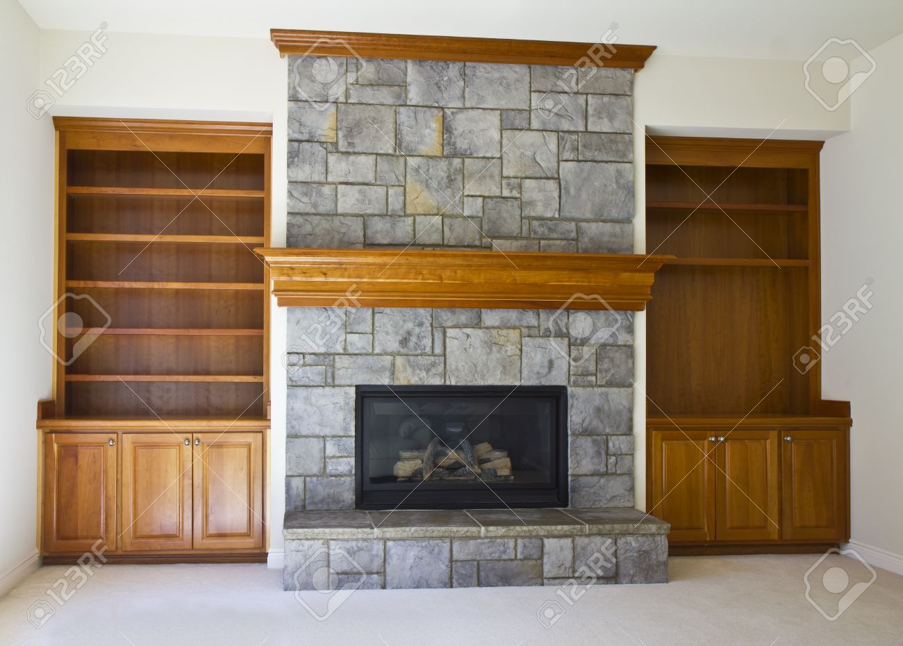 Stone Fireplace with book shelves on white wall - 10414896 Stone Fireplace with book shelves on white wall - 10414896