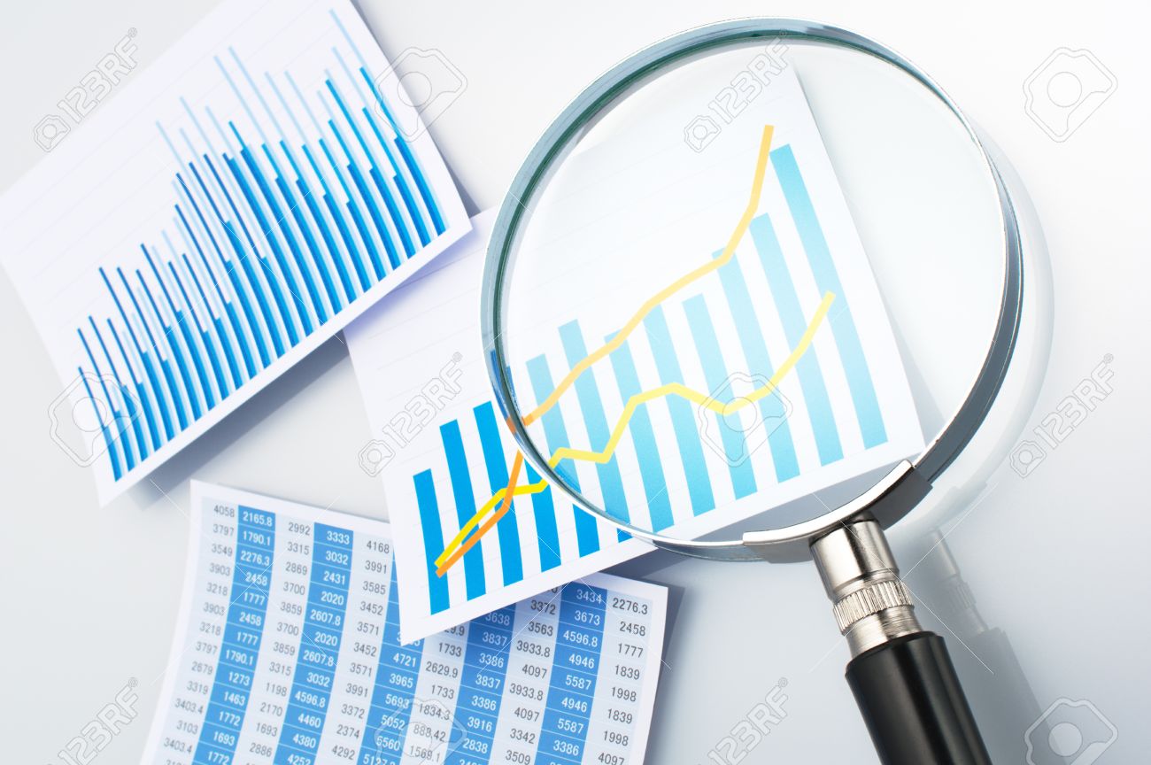 researching and reading data with magnifying glass three graphs and researching