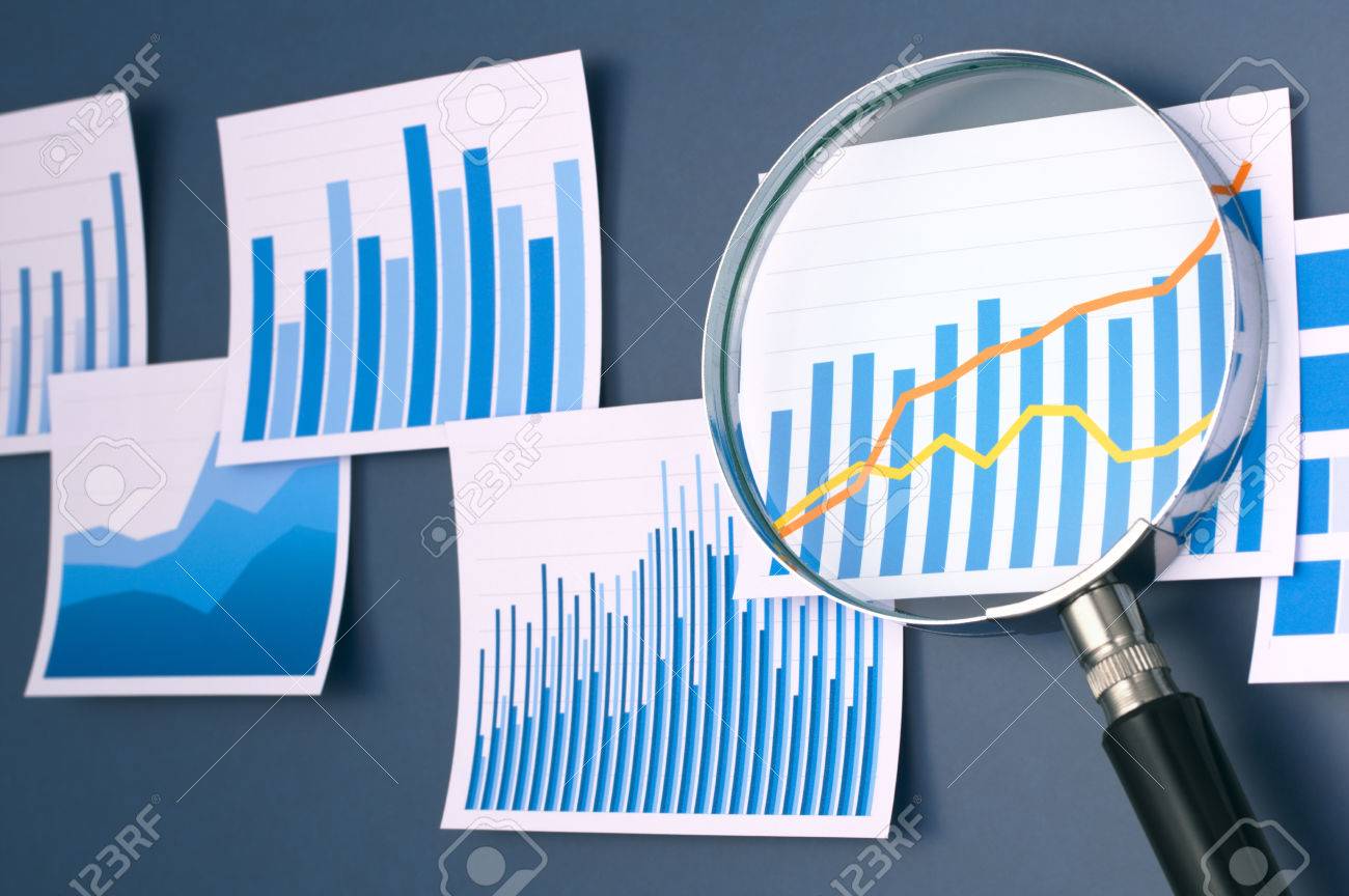 researching and analyzing data with magnifying glass many graphs researching
