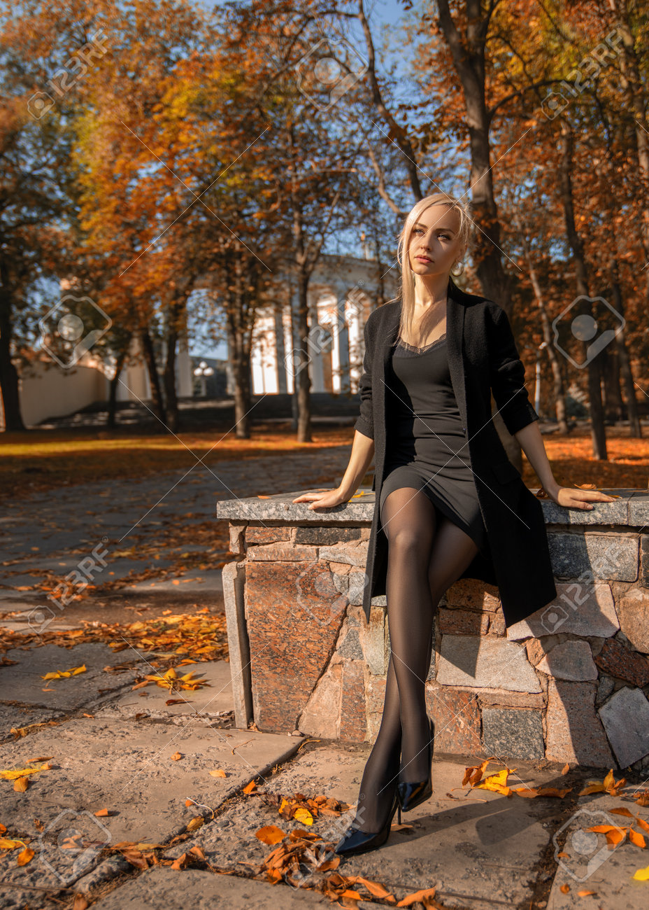 Beautiful Blonde Woman With Perfect Legs In Pantyhose Posing Outdoor At The  Autumn Street In The Lights Of The Setting Sun. Stock Photo, Picture and  Royalty Free Image. Image 160156600.