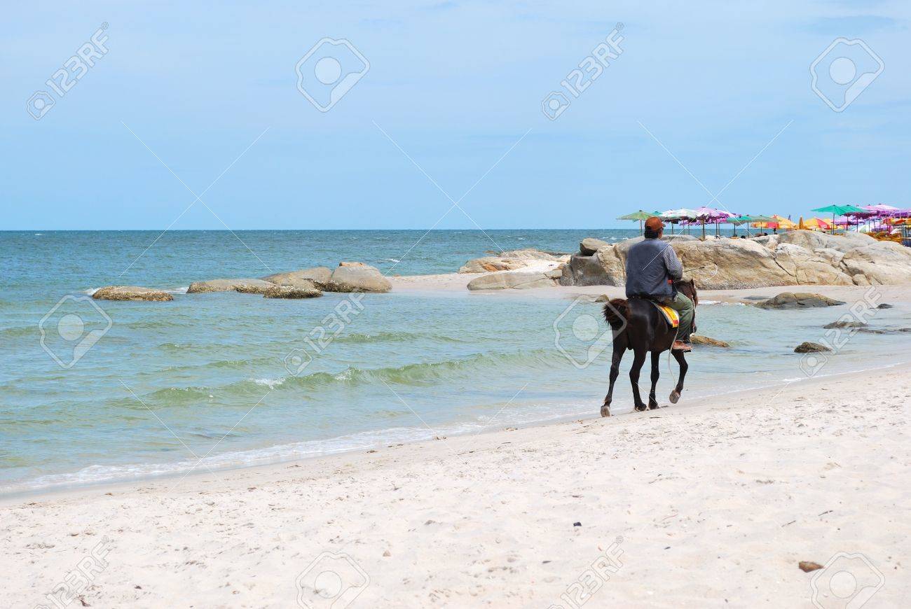 Beach With Rocks And Horse In Hua Hin Beach Thailand Stock Photo