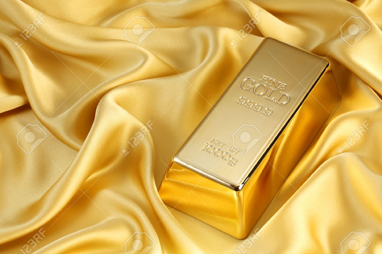 Photo of a 1kg gold bar on gold satin - 46617750 Photo of a 1kg gold bar on gold satin - 46617750