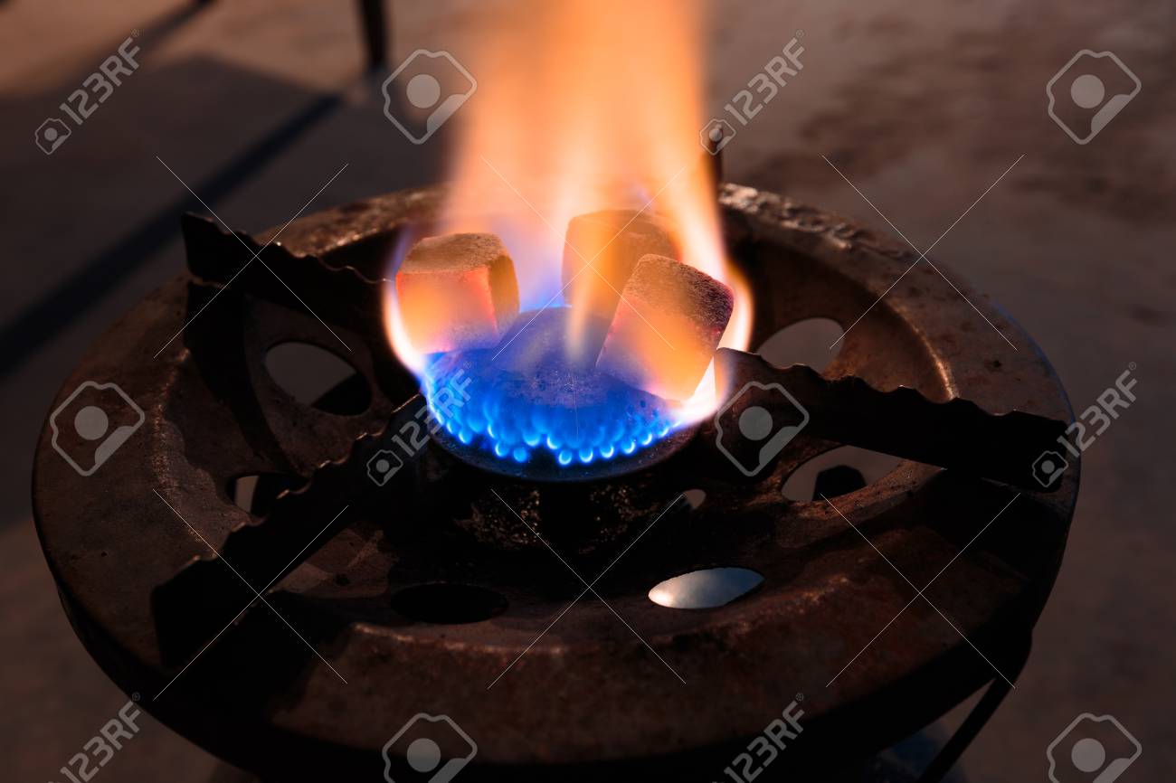 charcoal for shisha on a gas burner stock photo picture and royalty