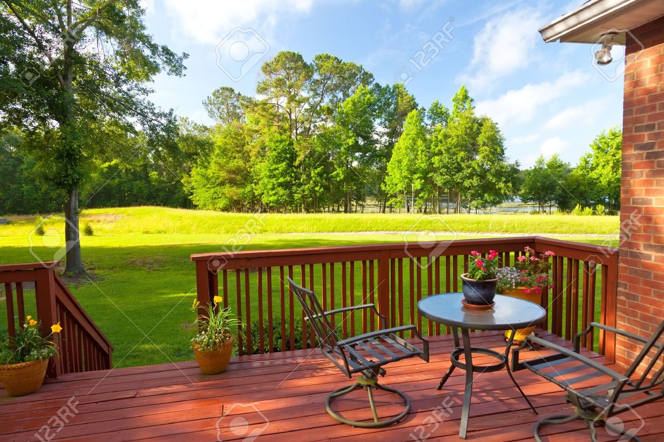 Residential backyard deck overlooking lawn and lake - 20864956 Residential backyard deck overlooking lawn and lake - 20864956