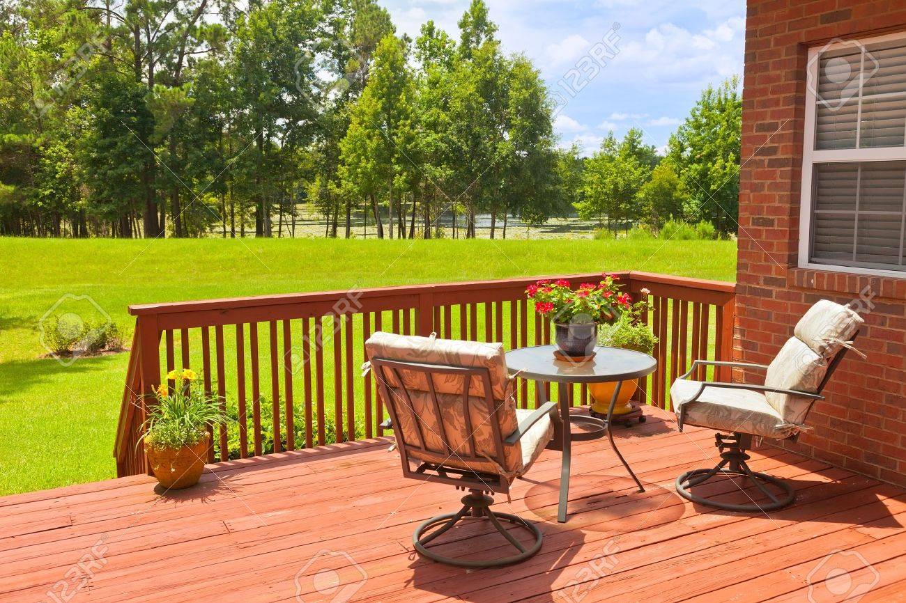Residential backyard deck overlooking lawn and lake - 20933355 Residential backyard deck overlooking lawn and lake - 20933355