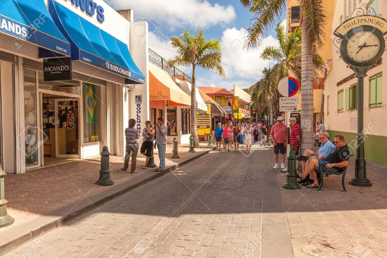 Philipsburg, St. Maarten - Jan. 19, 2011: Tourists shop along the busiest street in Philispburg, Front Street, for local souveniers and bargains. Most visitors are cruise passengers and only in port for the day. - 25220972 Philipsburg, St. Maarten - Jan. 19, 2011: Tourists shop along the busiest street in Philispburg, Front Street, for local souveniers and bargains. Most visitors are cruise passengers and only in port for the day. - 25220972