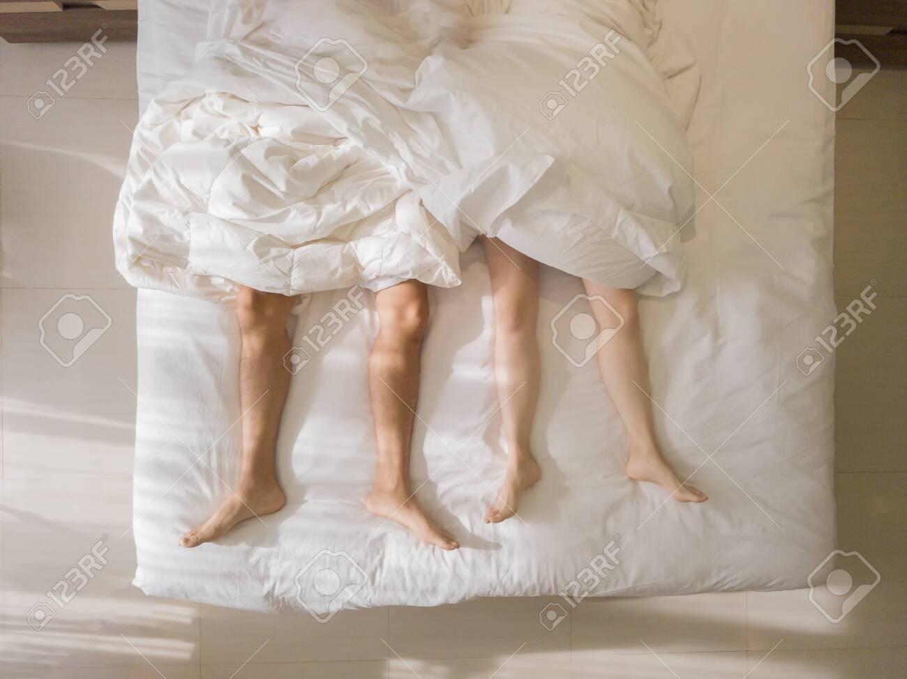 Top View Of Romantic Couple Sleeping Bare Feet Of Their Legs