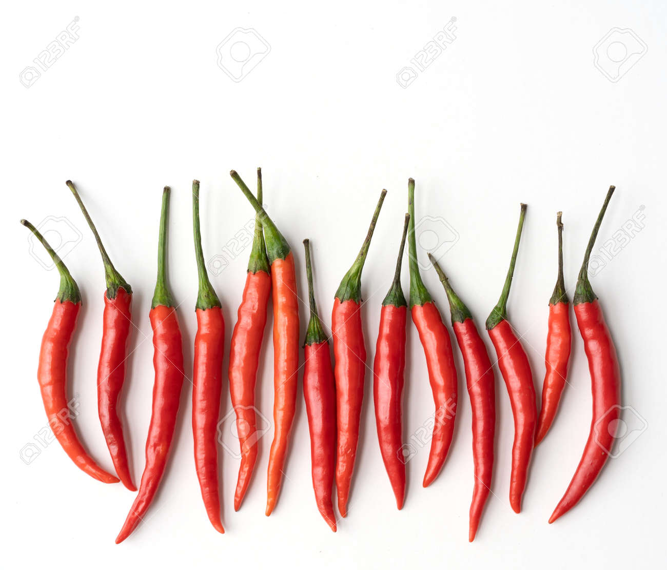 Chili peppers with sliced red chili peppers isolated on white background. Hot and spicy food. Vegetable. Seasoning ingredient. - 172003129 Chili peppers with sliced red chili peppers isolated on white background. Hot and spicy food. Vegetable. Seasoning ingredient. - 172003129