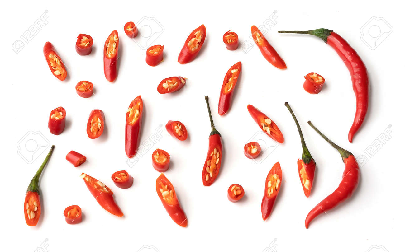 Chili peppers with sliced red chili peppers isolated on white background. Hot and spicy food. Vegetable. Seasoning ingredient. - 172003131 Chili peppers with sliced red chili peppers isolated on white background. Hot and spicy food. Vegetable. Seasoning ingredient. - 172003131