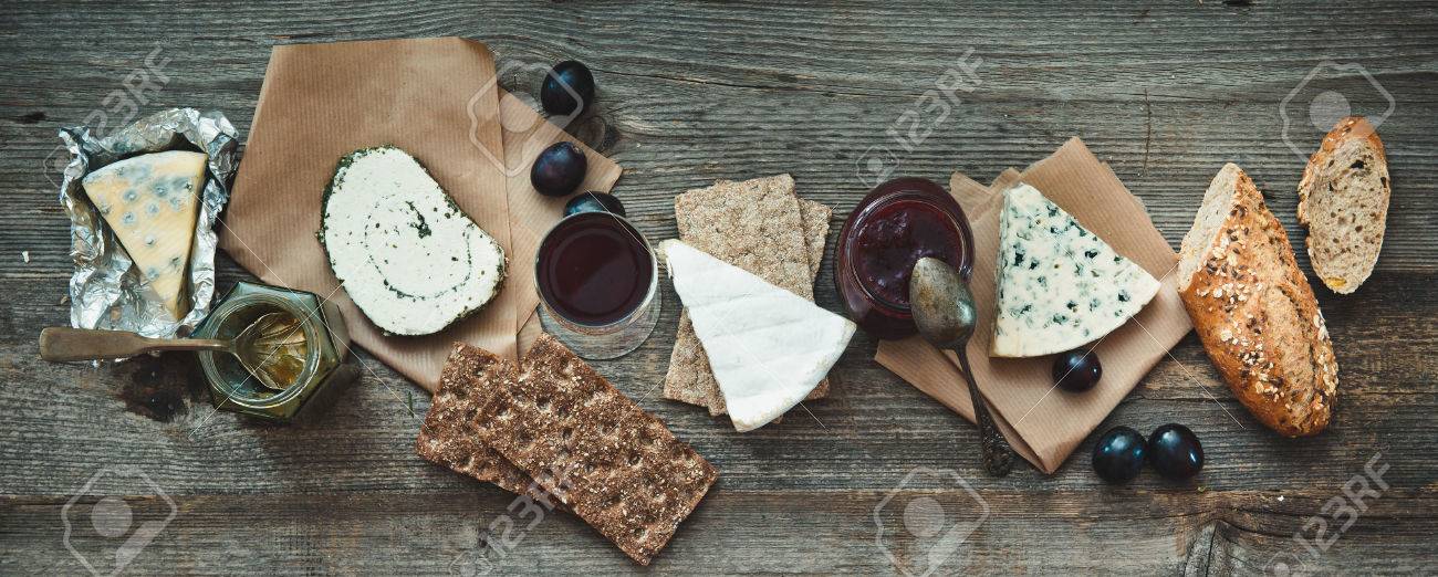 French food on a wooden background. Different types of cheese, wine and other ingredients on a wooden table - 43021487 French food on a wooden background. Different types of cheese, wine and other ingredients on a wooden table - 43021487