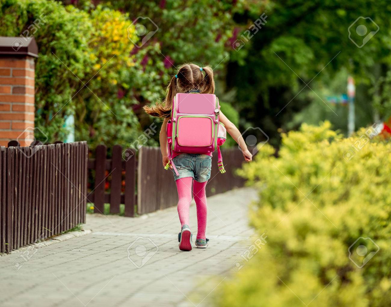 little girl with a backpack going to school. back view - 43021549 little girl with a backpack going to school. back view - 43021549