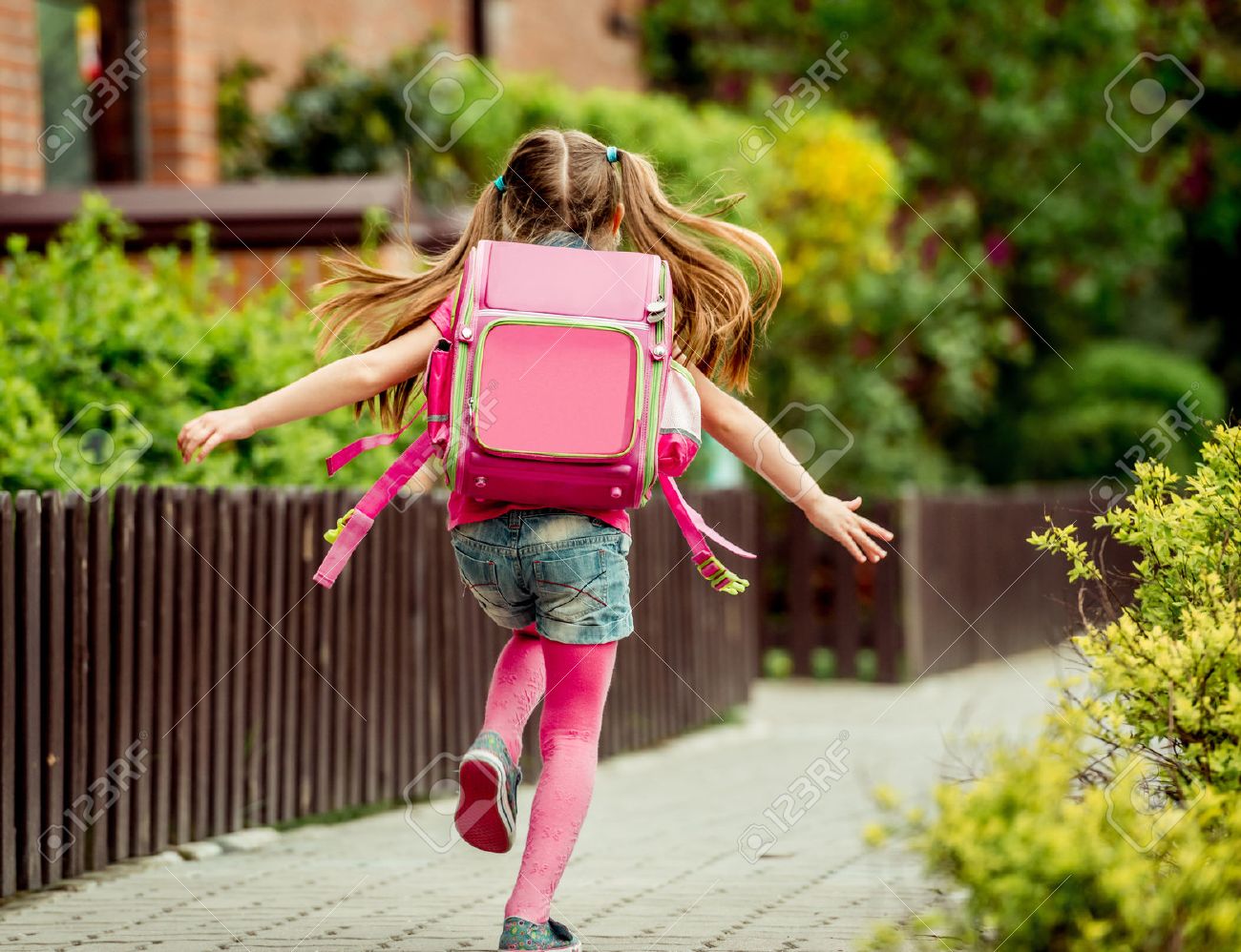 little girl with a backpack run to school. back view - 43021551 little girl with a backpack run to school. back view - 43021551