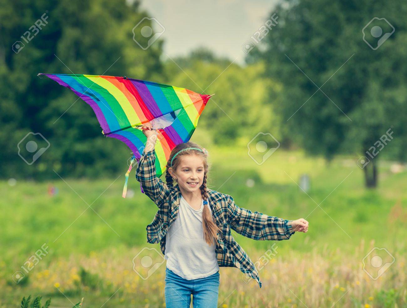 little cute girl flying a kite in a meadow on a sunny day - 44481331 little cute girl flying a kite in a meadow on a sunny day - 44481331