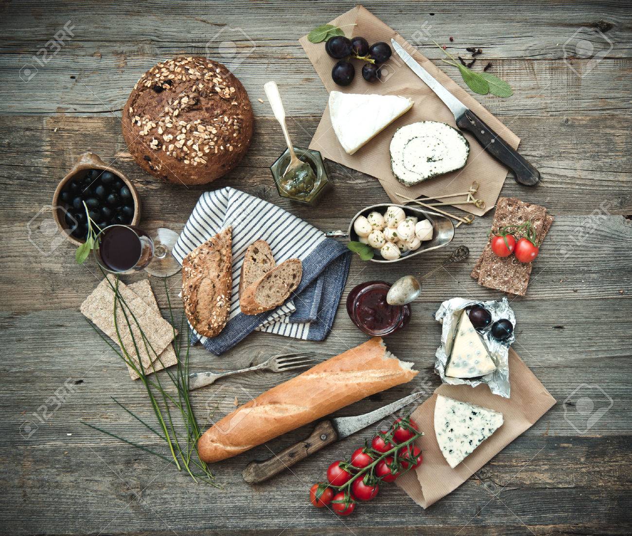 French food on a wooden background. Different types of cheese, wine and other ingredients on a wooden table - 45900264 French food on a wooden background. Different types of cheese, wine and other ingredients on a wooden table - 45900264