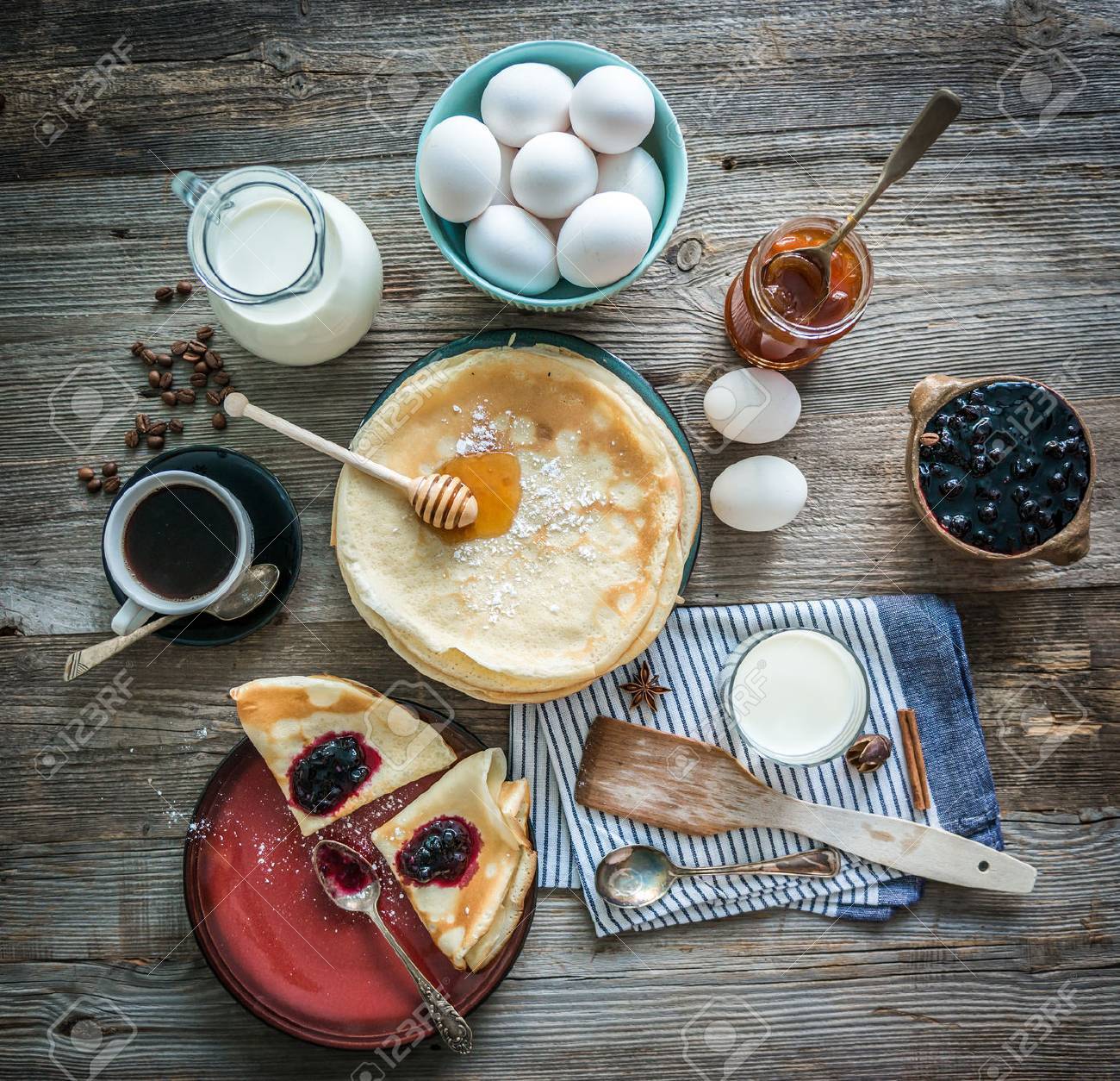 prepared pancakes and coffee among ingredients on wooden background - 47390017 prepared pancakes and coffee among ingredients on wooden background - 47390017